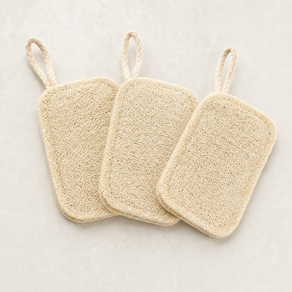 Three natural loofah dish scrubber pads with hanging loops
